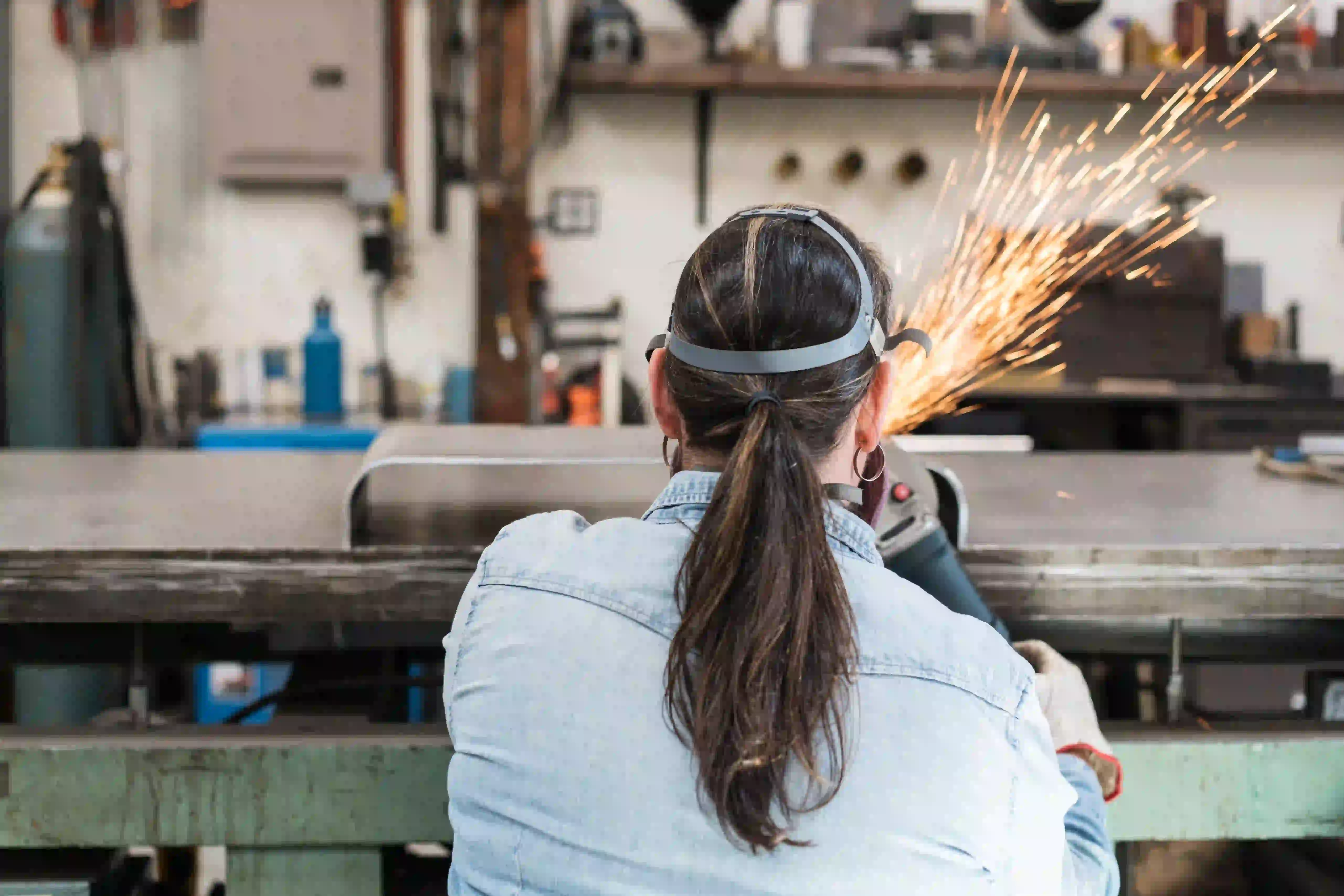 Woman working on metal